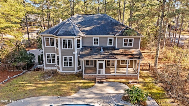 view of front property with a sunroom, a patio area, and a front lawn