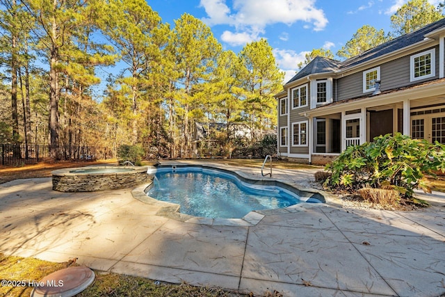 view of swimming pool featuring a patio area, an in ground hot tub, and a sunroom