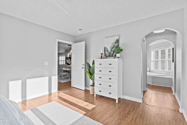 bedroom featuring hardwood / wood-style floors and a textured ceiling