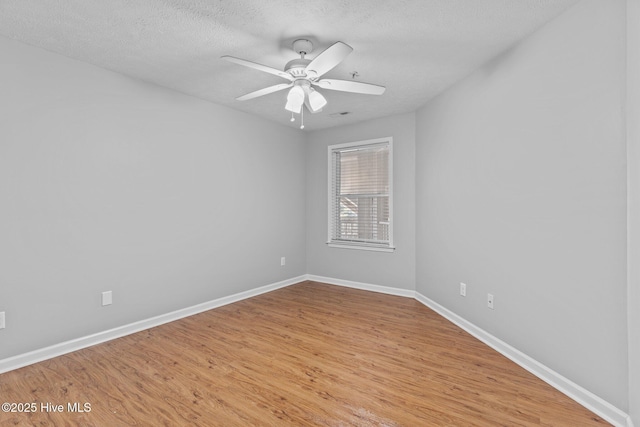 spare room with ceiling fan, light hardwood / wood-style flooring, and a textured ceiling