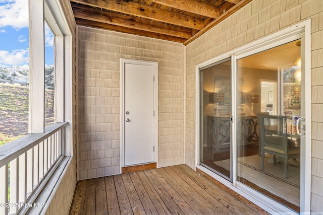 unfurnished sunroom with beamed ceiling