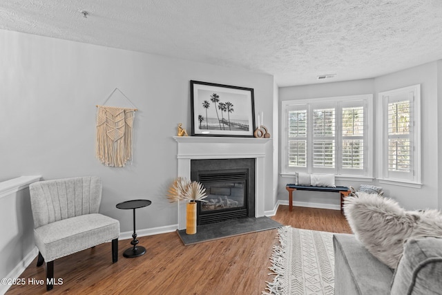 interior space with wood-type flooring and a textured ceiling