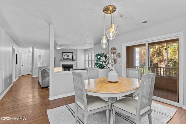 dining space featuring hardwood / wood-style floors and a textured ceiling