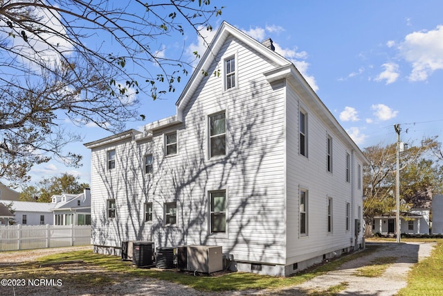 back of house featuring central AC unit