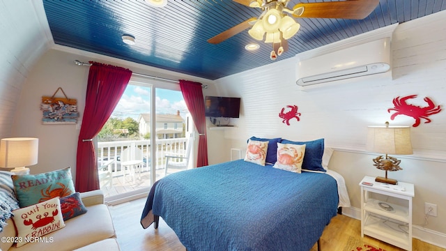 bedroom featuring access to exterior, ornamental molding, ceiling fan, light hardwood / wood-style flooring, and an AC wall unit