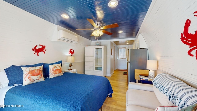 bedroom featuring ceiling fan, a wall mounted air conditioner, stainless steel fridge, wood ceiling, and light wood-type flooring