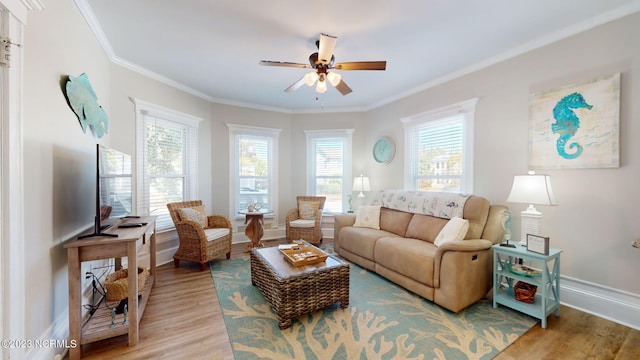 living room featuring hardwood / wood-style flooring, ceiling fan, and crown molding