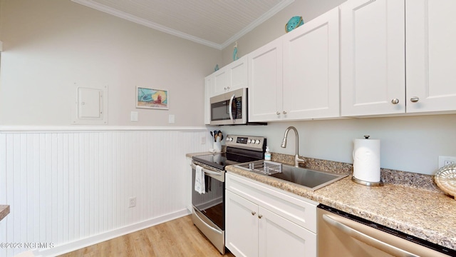 kitchen with white cabinets, crown molding, and appliances with stainless steel finishes