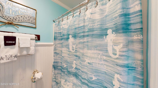 bathroom featuring a shower with curtain and ornamental molding