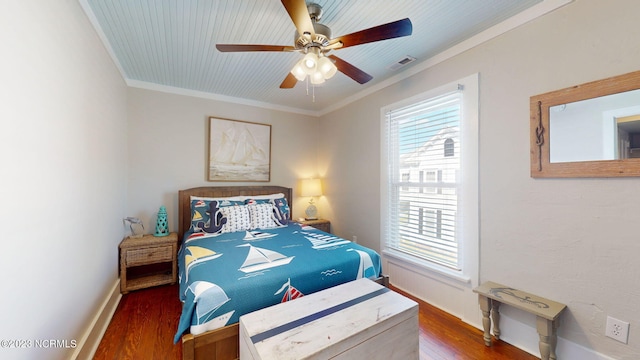 bedroom featuring ceiling fan, dark hardwood / wood-style flooring, and crown molding