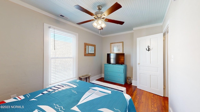 bedroom with ceiling fan, crown molding, and dark hardwood / wood-style floors