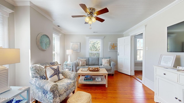 living room featuring ceiling fan, light hardwood / wood-style floors, and ornamental molding