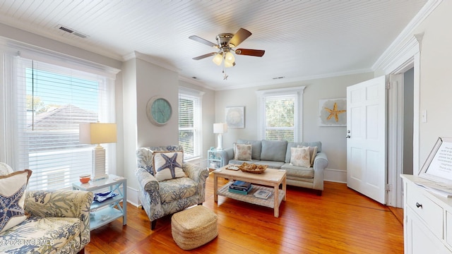 living room featuring ceiling fan, light wood-type flooring, and ornamental molding