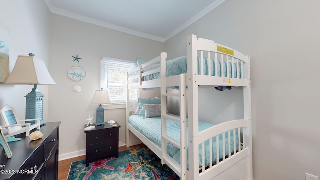 bedroom with dark hardwood / wood-style flooring and ornamental molding