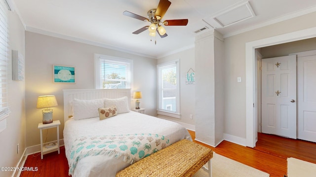 bedroom featuring hardwood / wood-style floors, ceiling fan, and ornamental molding