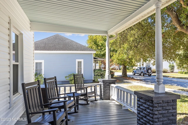 wooden terrace with a porch