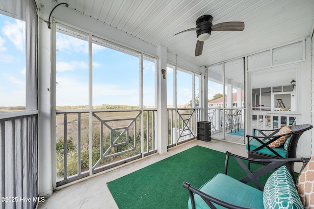 sunroom featuring ceiling fan