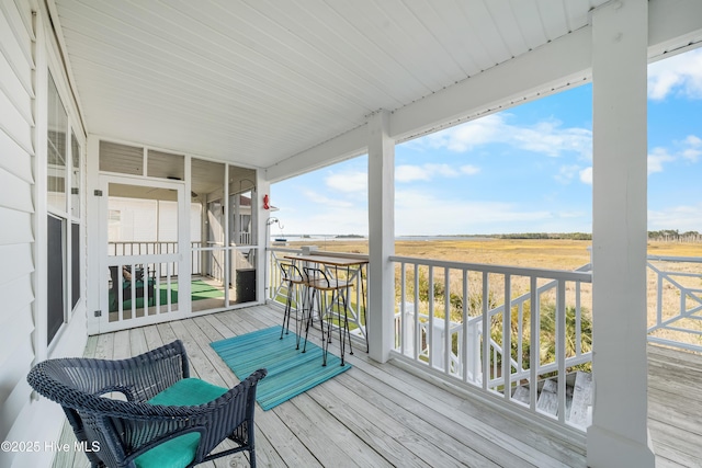 wooden deck with a rural view