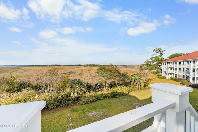 view of yard featuring a rural view and a balcony