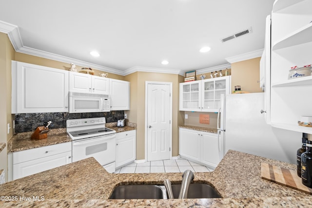 kitchen featuring white appliances, white cabinets, sink, stone countertops, and light tile patterned flooring