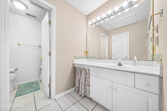 bathroom with tile patterned flooring, vanity, and toilet