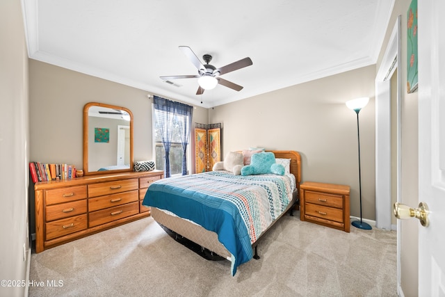 bedroom featuring ceiling fan, light colored carpet, and crown molding