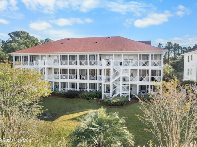 rear view of property featuring a yard