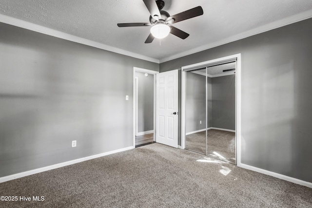 unfurnished bedroom featuring ceiling fan, a closet, carpet floors, and ornamental molding