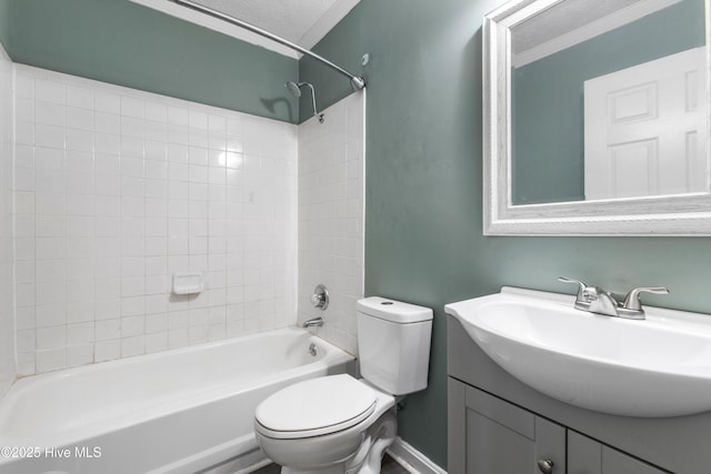 full bathroom featuring ornamental molding, a textured ceiling, toilet, vanity, and tiled shower / bath