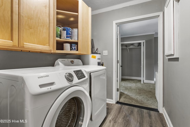 washroom featuring cabinets, electric water heater, dark hardwood / wood-style flooring, independent washer and dryer, and a textured ceiling