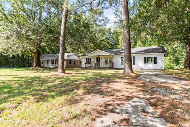 ranch-style house with a porch and a front lawn