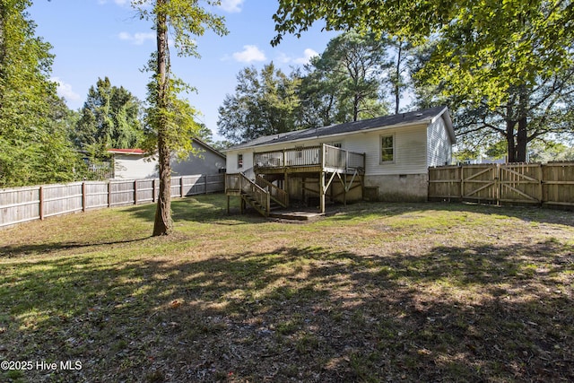 rear view of house with a yard and a deck