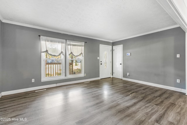 interior space featuring dark wood-type flooring, a textured ceiling, and ornamental molding