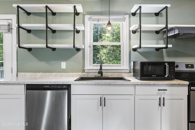 kitchen with sink, ventilation hood, decorative light fixtures, white cabinets, and appliances with stainless steel finishes