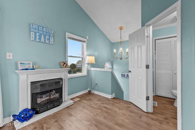 washroom featuring hardwood / wood-style floors, crown molding, and an inviting chandelier