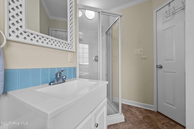 bathroom featuring backsplash, crown molding, sink, and a shower with door