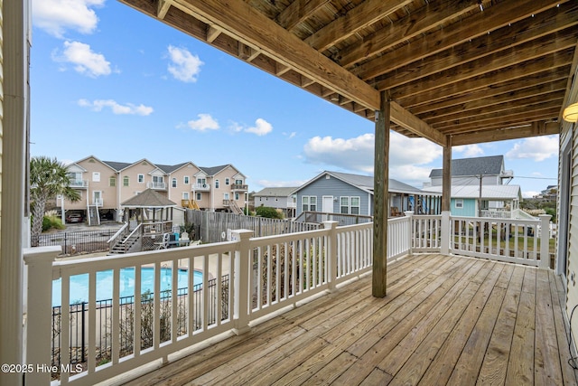 deck featuring a fenced in pool