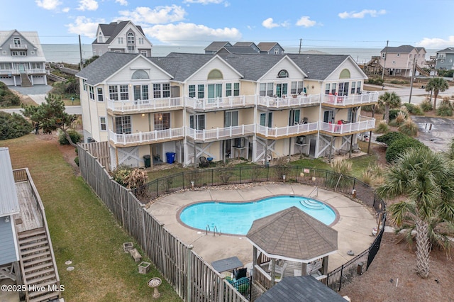 view of swimming pool featuring a gazebo, a yard, and a water view