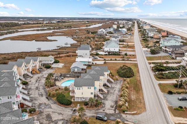 drone / aerial view with a water view and a view of the beach