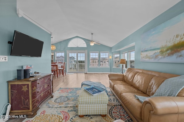 living room featuring wood-type flooring, plenty of natural light, ceiling fan, and lofted ceiling