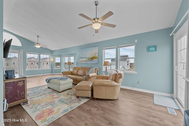 living room featuring light hardwood / wood-style flooring, vaulted ceiling, and ceiling fan