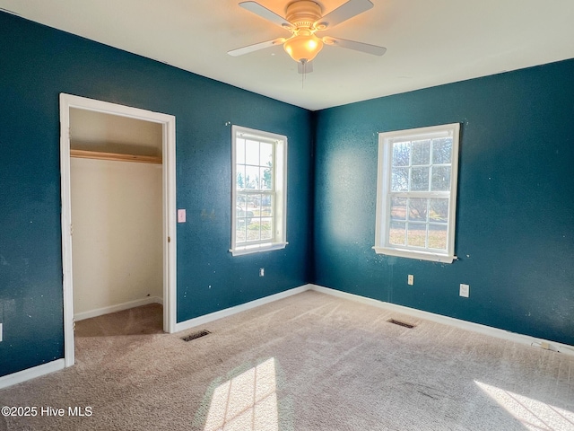 unfurnished bedroom featuring ceiling fan and carpet floors