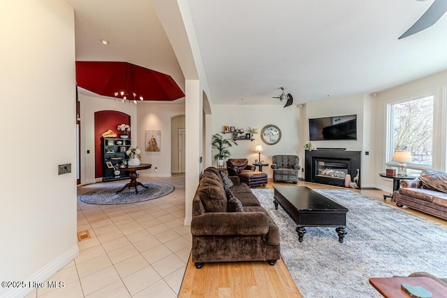 living room with ceiling fan and light tile patterned floors