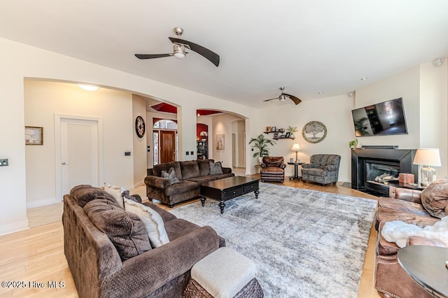 living room with ceiling fan and light wood-type flooring