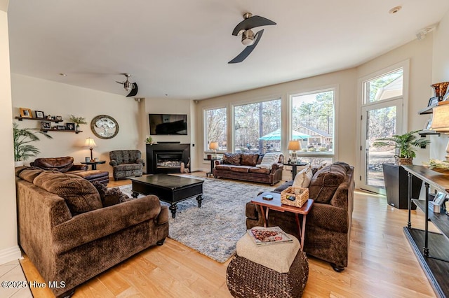 living room featuring ceiling fan and light hardwood / wood-style floors