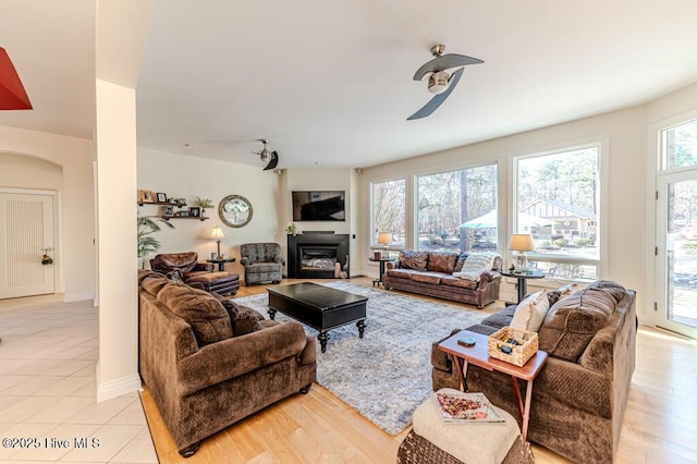 living room with ceiling fan and light wood-type flooring