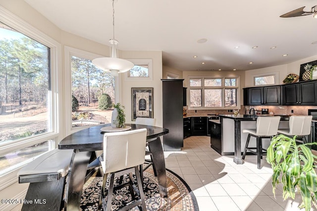 tiled dining space with ceiling fan