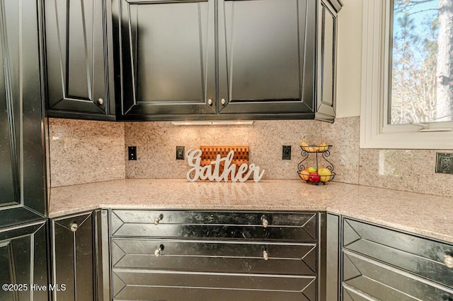 kitchen with light stone countertops and backsplash