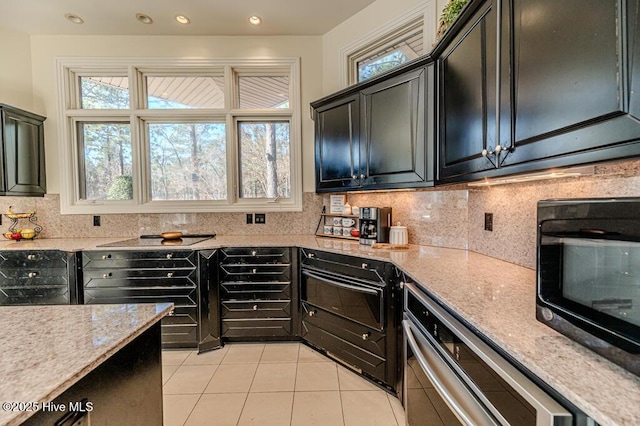 kitchen with light stone countertops, light tile patterned floors, and tasteful backsplash