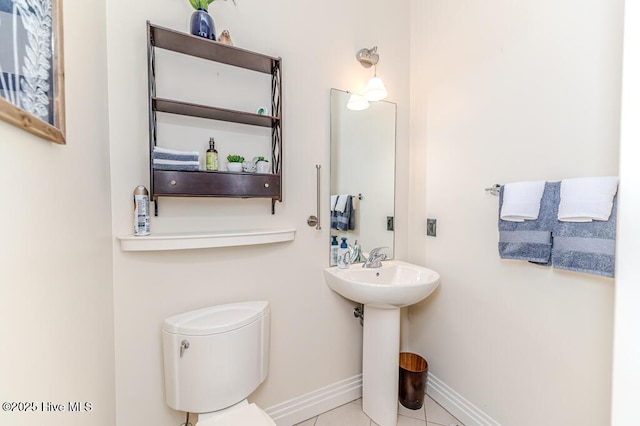 bathroom with tile patterned flooring, toilet, and sink